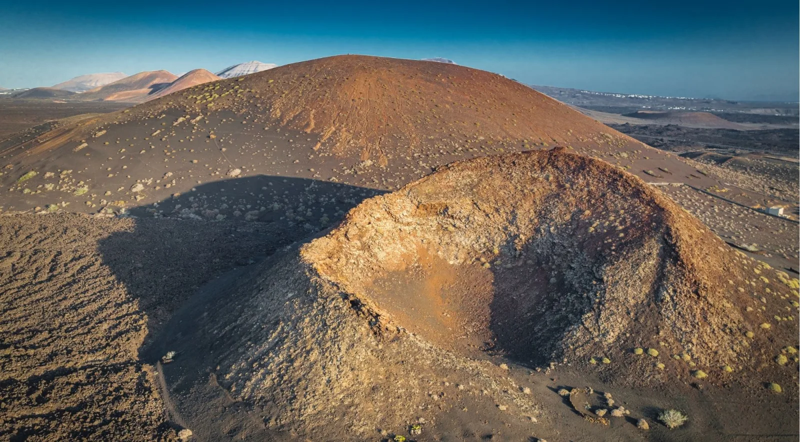 Aerial view of Caldera Colorada, an open red-walled crater in Lanzarote's volcanic interior